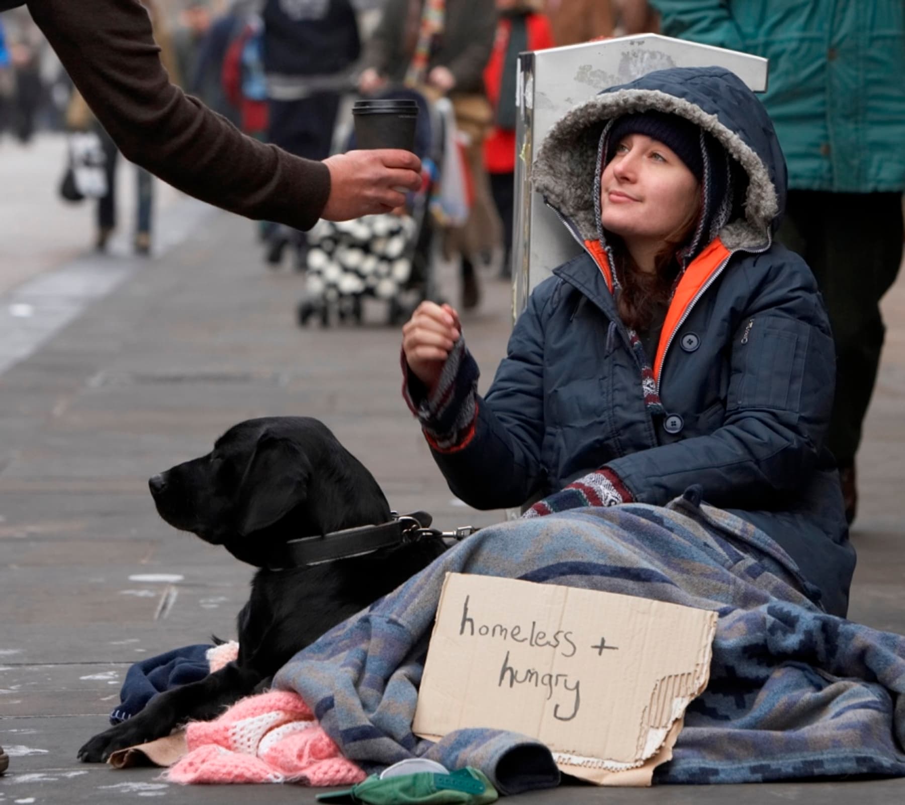 A person receiving help while sitting outdoors.